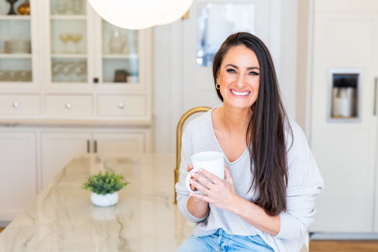 Nutrition by Gina; Gina Lilley, Registered Dietitian Nutritionist standing with her hands in her pockets, smiling.