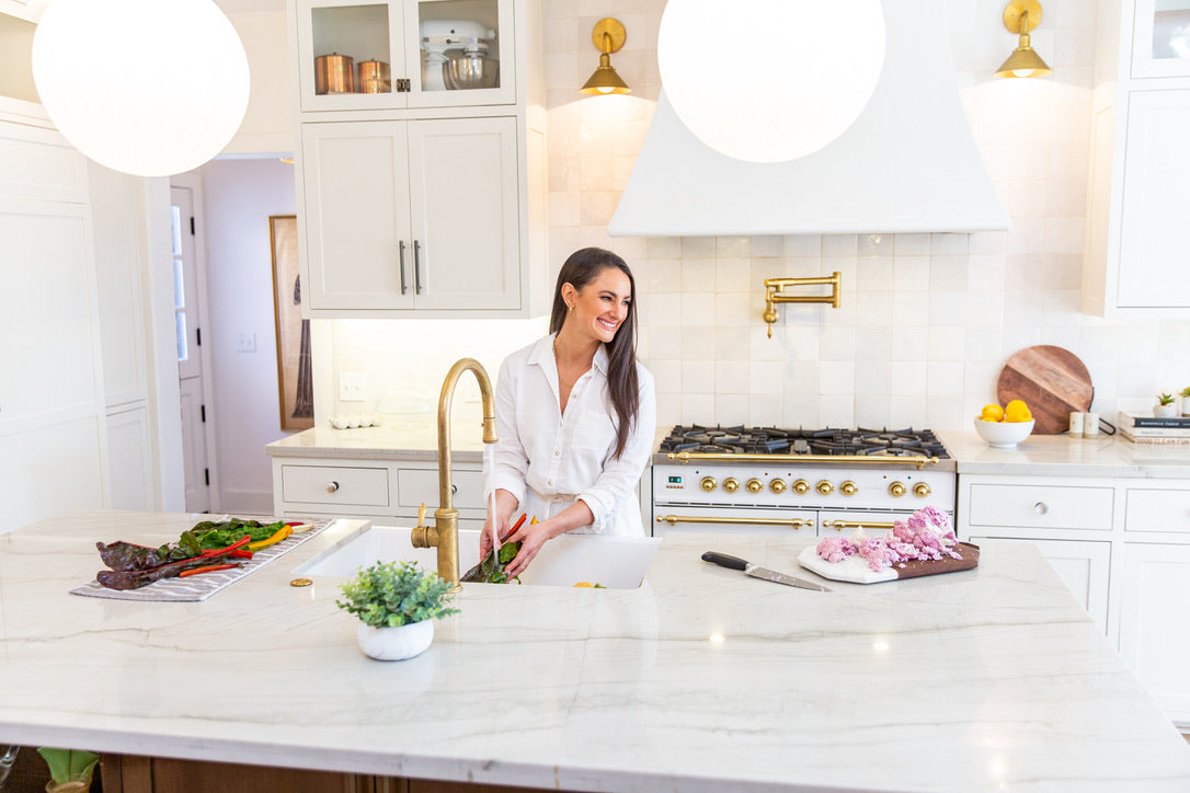 Nutrition by Gina; Registered Dietitian Nutritionist, Gina Lilley washing vegetables in her kitchen.